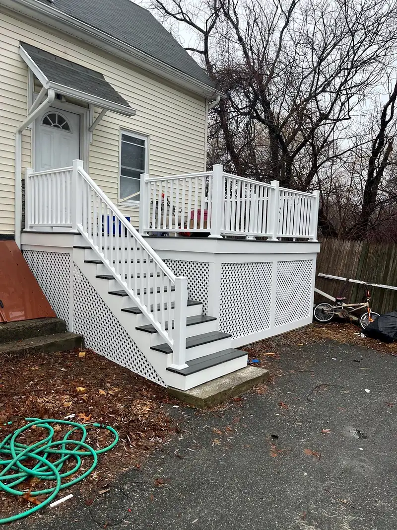 White deck stairs and railing with lattice skirting